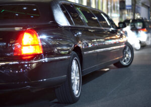 Low angle view of black limousine in city at night